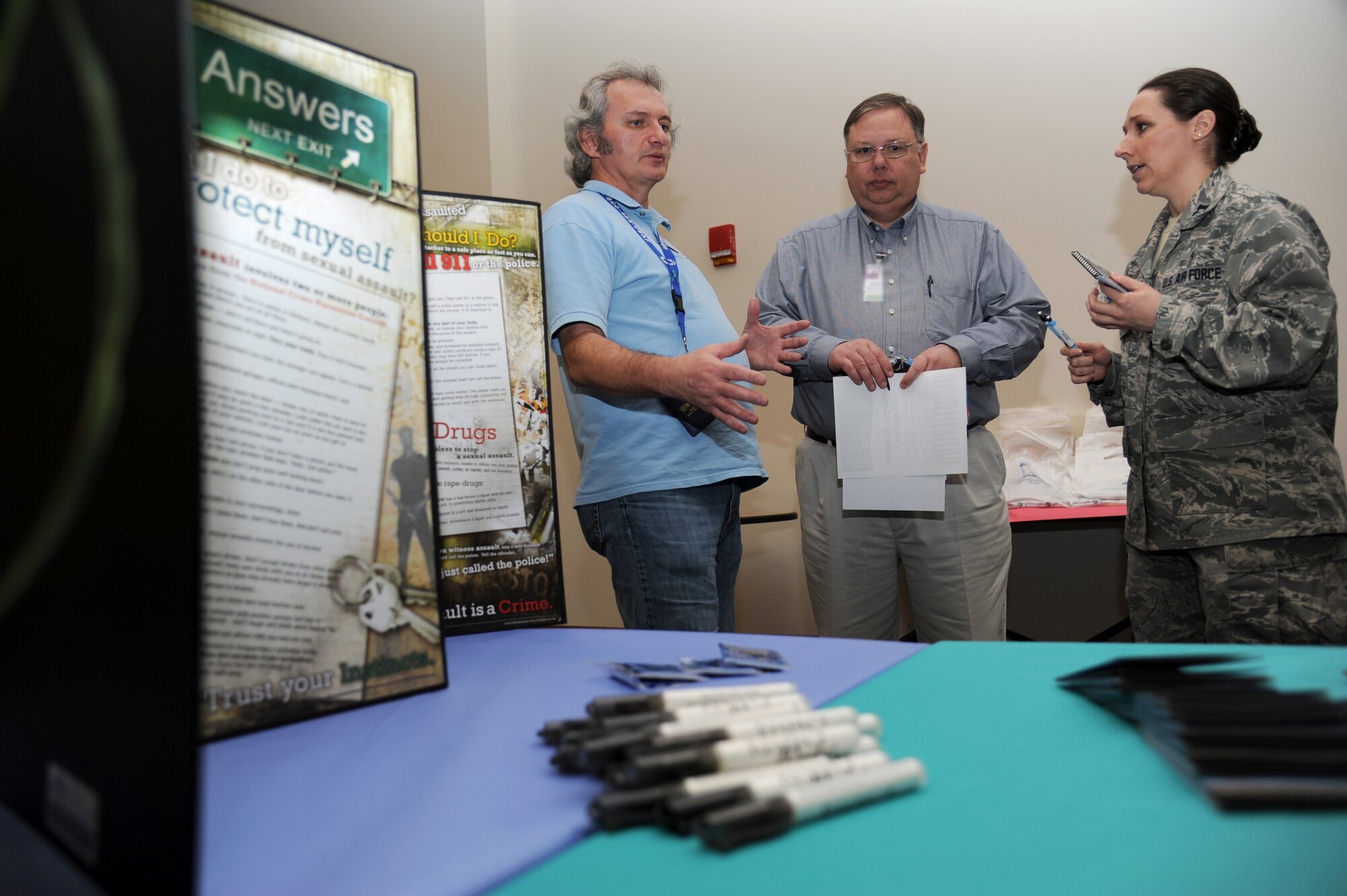 Barry Newman, 81st Training Wing Sexual Assault Prevention and Response office, provides information about the SAPR office to Carlton Harrison and Capt. Katie Ragan, 81st Medical Operations Squadron, during the military preparedness exposition Feb. 7, 2013, at the Roberts Consolidated Aircraft Maintenance Facility.  Various agencies set up information displays and booths to assist those who have recently returned from a deployment or will soon be deploying.  (U.S. Air Force photo by Kemberly Groue)