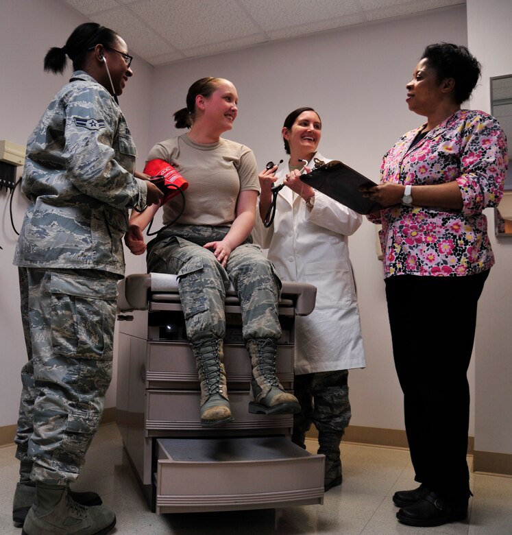 Airman 1st Class Jazmine Thomas, 779th Medical Group medical technician; Capt. Brea Whitehair, 779 MDG family medicine physician; and Nwatu Uloma, 779 MDG family health clinic registered nurse, simulate taking a pulse on Airman 1st Class Audra Smith, 779 MDG family health technician, on Feb.7, 2013 on Joint Base Andrews, Md. Patients are tended to by a clinician-led care team which provides for all their needs. (U.S. Air Force photo/ Airman 1st Class Erin O’Shea)      