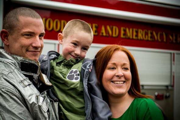 U.S. Air Force Tech. Sgt. Eric Kunzman, former 23d Civil Engineer Squadron firefighter, his son, Christian, and wife, Crystal, share smiles Feb. 8, 2013, at Sallas Mahone Elementary School, Valdosta, Ga. The family reunited after Kunzman’s year-long tour to Osan Air Base, Korea. (U.S. Air Force photo by Staff Sgt. Jamal D. Sutter/Released) 