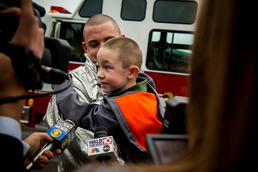Six-year-old Christian Kunzman, son of U.S. Air Force Tech. Sgt. Eric Kunzman, former 23d Civil Engineer Squadron firefighter, answers questions from local Valdosta, Ga., media Feb. 8, 2013, at Sallas Mahone Elementary School. Kunzman returned home from a year-long tour to Osan Air Base, Korea, and surprised his son, who thought he would greet his father at the airport later that day. (U.S. Air Force photo by Staff Sgt. Jamal D. Sutter/Released)   