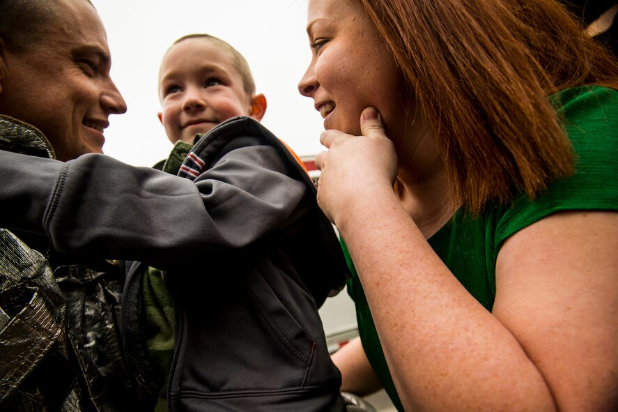 U.S. Air Force Tech. Sgt. Eric Kunzman, former 23d Civil Engineer Squadron firefighter, and his wife, Crystal, embrace their son, Christian, Feb. 8, 2013, at Sallas Mahone Elementary School, Valdosta, Ga. Kunzman surprised his son at school after returning from a year-long tour to Osan Air Base, Korea. (U.S. Air Force photo by Staff Sgt. Jamal D. Sutter/Released)  