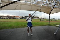 Trainer band row:
Hold onto the TRX and back away until you feel tension in the straps.  Your body should form a 45 to 60 degree angle to the floor, and your arms should be parallel to the floor, palms down.  Pull your body toward the anchor point by bringing the handles toward the sides of your chest as you rotate your palms inward.  Your elbows should be at 45 degrees, pause and return to the starting position. (U. S. Air Force photo by Don Lindsey) 