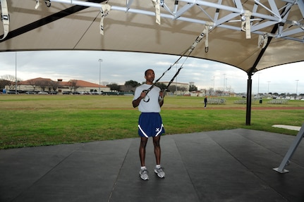 Trainer band row:
Hold onto the TRX and back away until you feel tension in the straps.  Your body should form a 45 to 60 degree angle to the floor, and your arms should be parallel to the floor, palms down.  Pull your body toward the anchor point by bringing the handles toward the sides of your chest as you rotate your palms inward.  Your elbows should be at 45 degrees, pause and return to the starting position. (U. S. Air Force photo by Don Lindsey) 