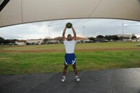 Medicine Ball Slam:
Stand with your feet a little wider than shoulder width and your toes pointed out at a slight angle.  Bend at your hips and knees and grab the ball.  Without allowing your lower back to round, pull your torso back and up, thrust your hips forward, and stand up with the ball at chest level.  Press the ball overhead, and then slam it to the ground.  Drop your hips to the starting position as you slam.  (U.S. Air Force photo by Don Lindsey)
