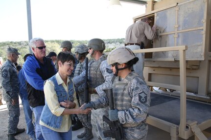 Texas Sen.  Donna Campbell shakes hand with Air Force Master Sgt. Pearl Alvarezswartz, while in back, Texas Rep. Lyle Larson, shakes hands with Air Force Tech Sgt. Jeremy Oulette after the HMMWV Egress Assistance Trainer exhibition.  Texas Legislative Day was hosted by the 502nd Air Base Wing and held at Joint Base San Antonio-Camp Bullis Feb. 8.   (U.S. Air Force photo by Joel Martinez)