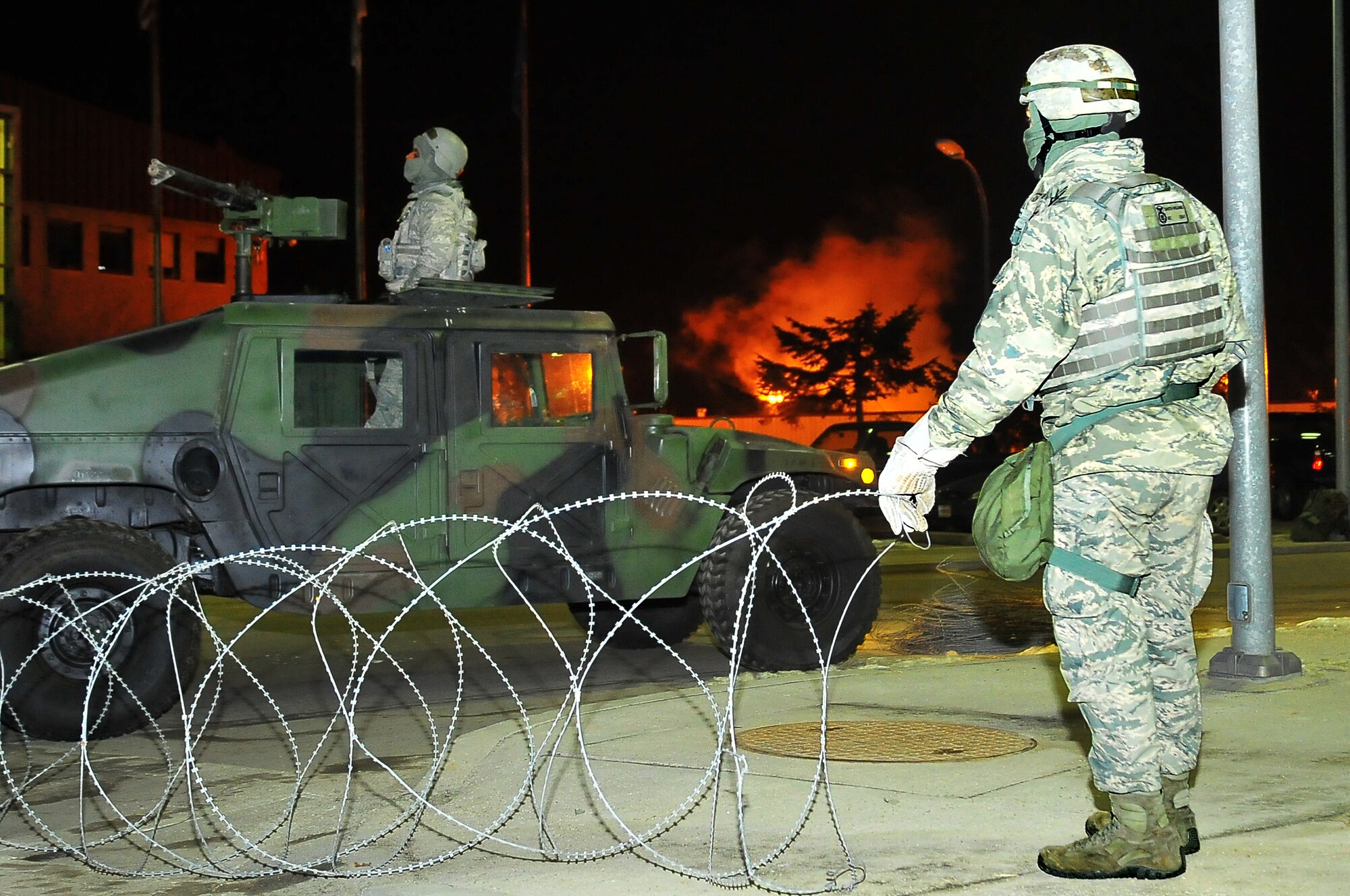Security Forces members lay down C-Wire and guard building 1097 during exercise Beverly Bulldog 13-02 at Osan Air Base, Republic of Korea, Feb. 11, 2013.  Throughout the week there will be different scenarios that will test Team Osan’s ability to defend the base and conduct daily operations during a heightened state of readiness.  (U.S. Air Force photo/Staff Sgt. Emerson Nuñez) 