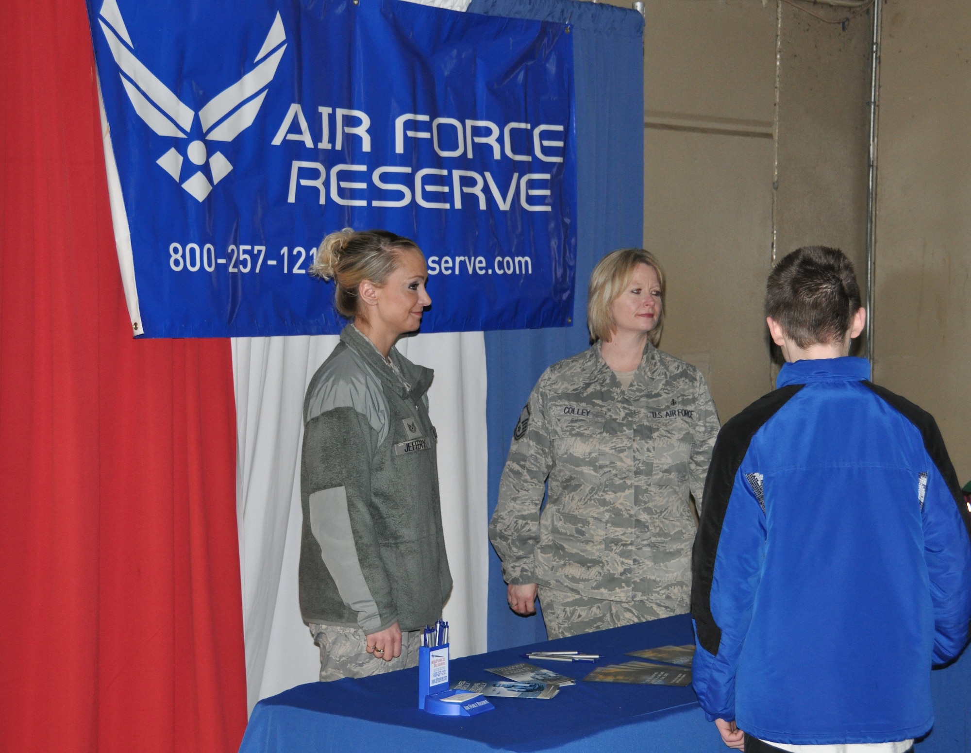 Tech. Sgt. Sammy Jeffery, an Air Force Reserve recruiter, and Master Sgt. Michelle Colley, 477th Aerospace Medicine Flight, discuss benefits of the Reserve with patrons at the Alaska Aces hockey game Feb. 9. The 477th FG has positions available for those who want to live in Alaska and serve their country.(U.S. Air Force Reserve photo/Tech. Sgt. Dana Rosso)