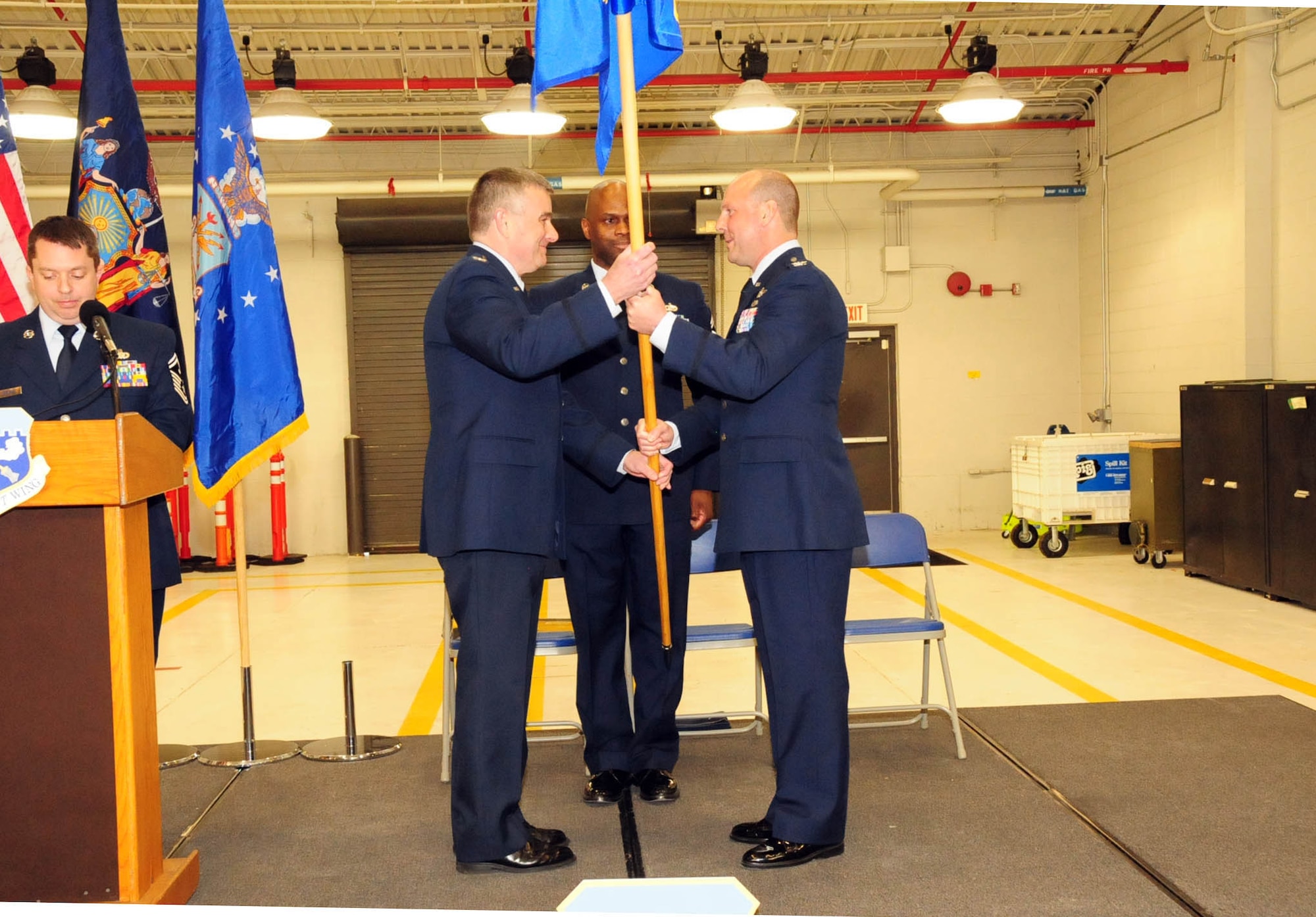 Col. John Higgins, the commander of the 107th Airlift Wing hands the Operations Group flag to Col.  Michael  Bank as he assumes command of the Operations Group at the Niagara Falls Reserve Station on Feb, 10, 2013 (Air National Guard Photo/Senior Master Sgt. Ray Lloyd)