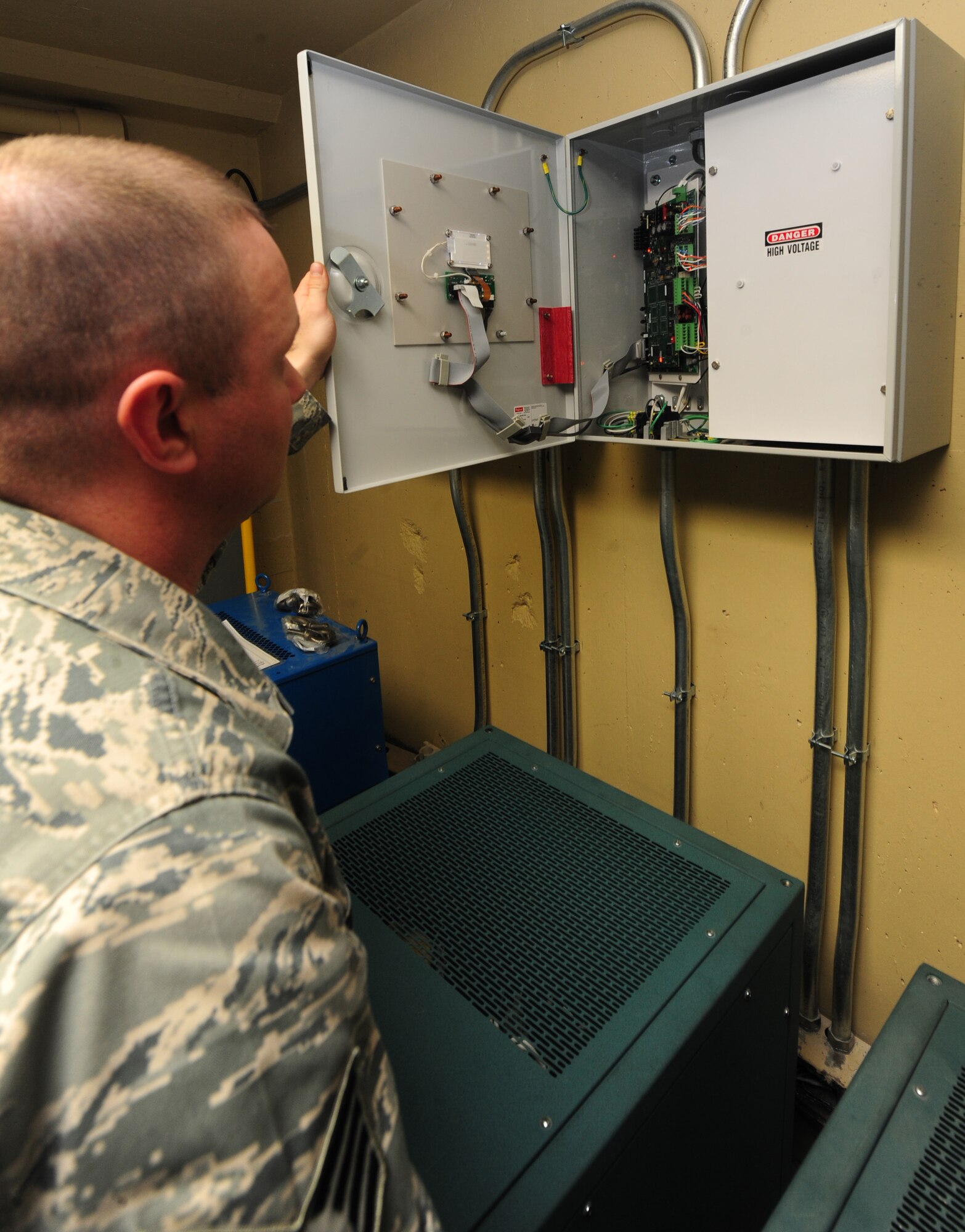 WHITEMAN AIR FORCE BASE, Mo. -- Staff Sgt. Clint Smith, 509th Civil Engineer Squadron electrical systems craftsman, inspects an electrical box, Jan. 29. The electrical box shows electricians the status of the amperage and current of an electrical system. (U.S. Air Force photo/Staff Sgt. Nick Wilson) (Released)