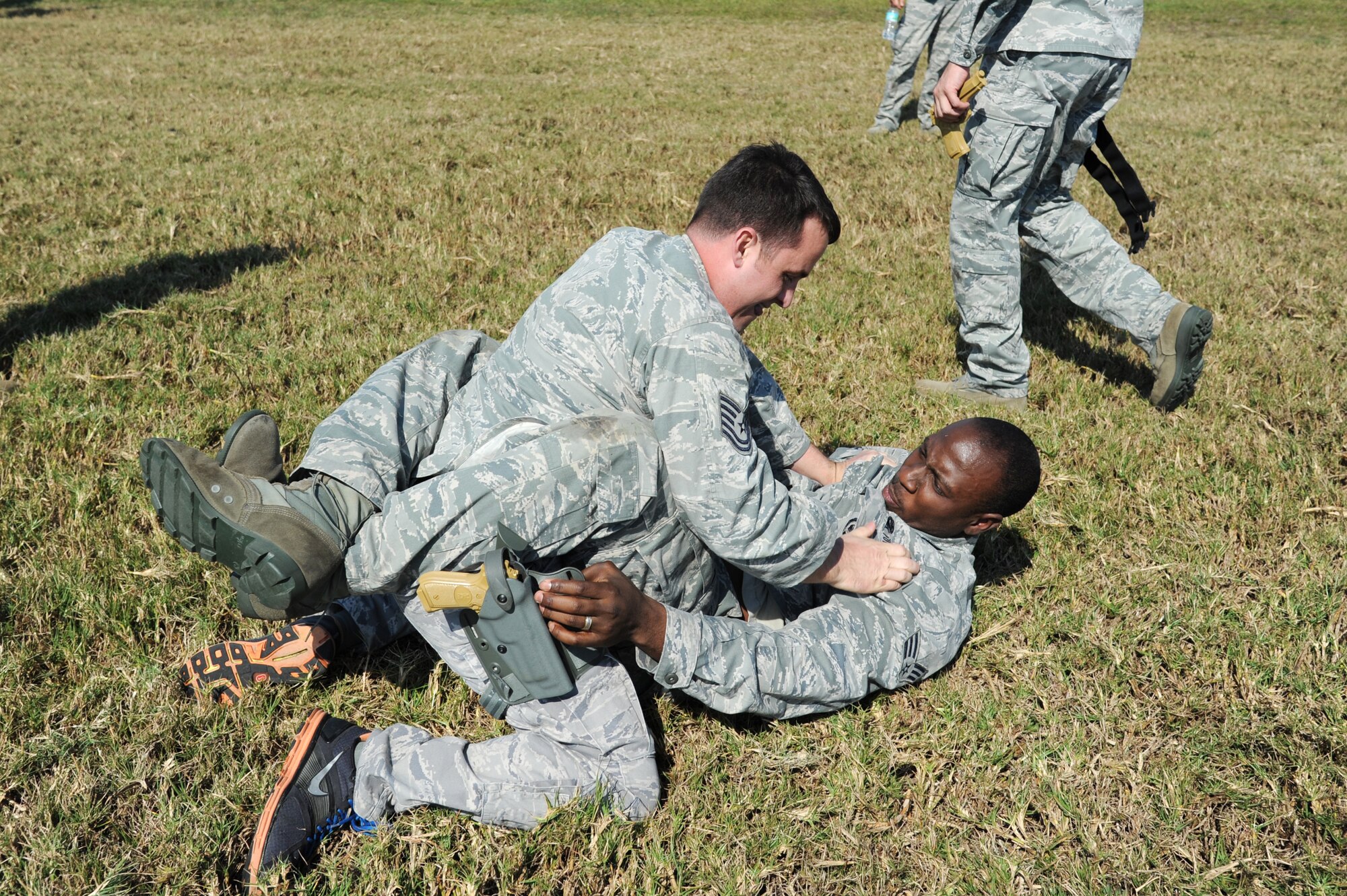Tech. Sgt. Josh Rapoza, 927th Security Forces Squadron, and Darius Peterson, 927th SFS, wrestle for control of a fake weapon during a security forces combatives training session at MacDill Air Force Base, February 10, 2013.  The 927th Security Forces Squadron, a reserve unit based at MacDill AFB, is implementing a new combative training program designed to help security forces Airmen better protect themselves and others in case of a hand-to-hand struggle against an aggressor.  