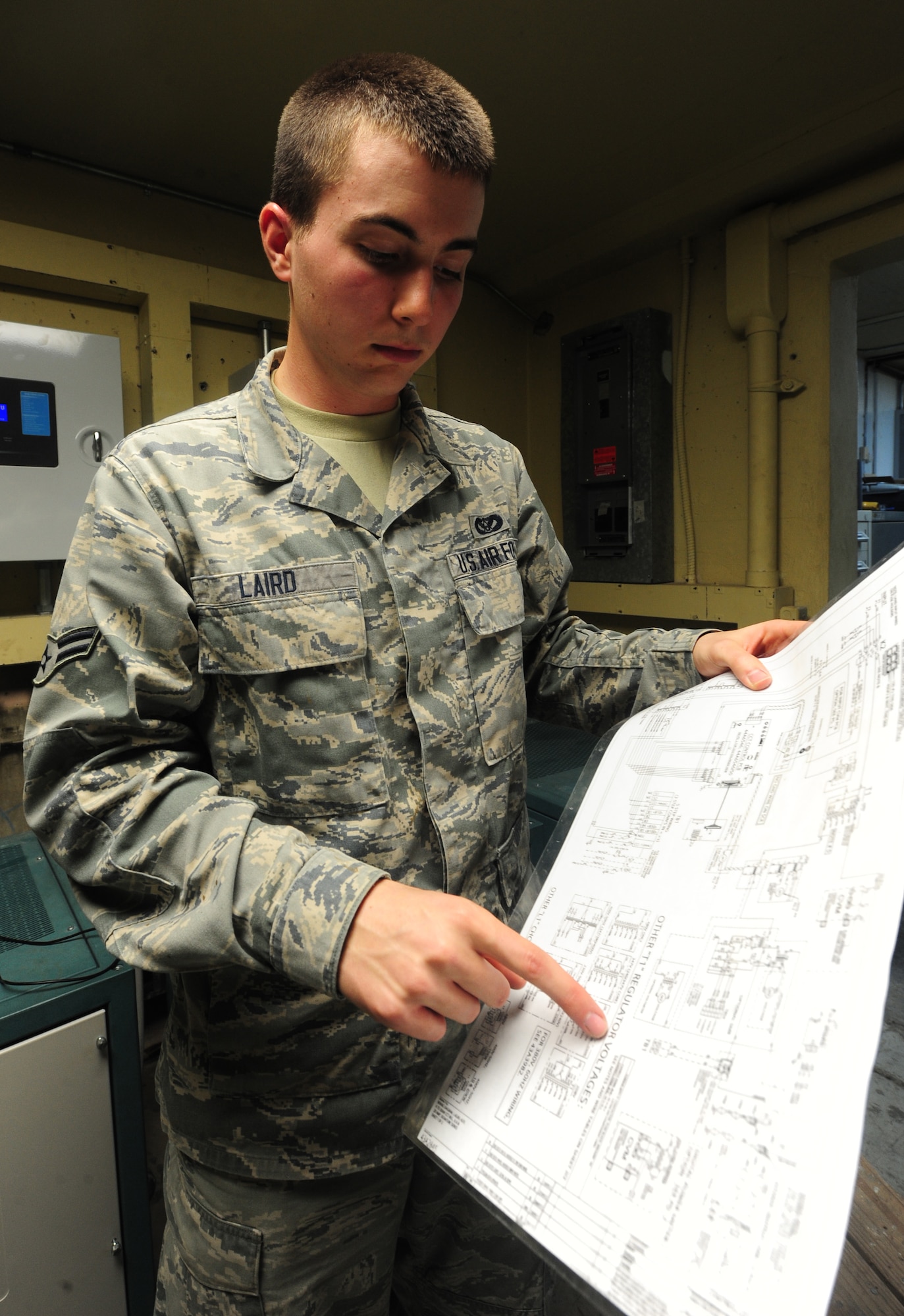 WHITEMAN AIR FORCE BASE, Mo. -- Airman 1st Class Devin Laird, 509th Civil Engineer Squadron electrical systems apprentice, reads a schematic diagram to see where to perform maintenance, Jan. 29. The schematic diagram shows electricians a map of how circuits are hooked up and where they are going. (U.S. Air Force photo/Staff Sgt. Nick Wilson) (Released)