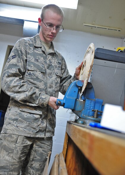 WHITEMAN AIR FORCE BASE, Mo. -- Airman 1st Class Henry Fox, 509th Civil Engineer Squadron electrical systems apprentice, secures an airfield plate before performing maintenance on it, Jan. 29. The plate is a component of an airfield lighting fixture. (U.S. Air Force photo/Staff Sgt. Nick Wilson) (Released)