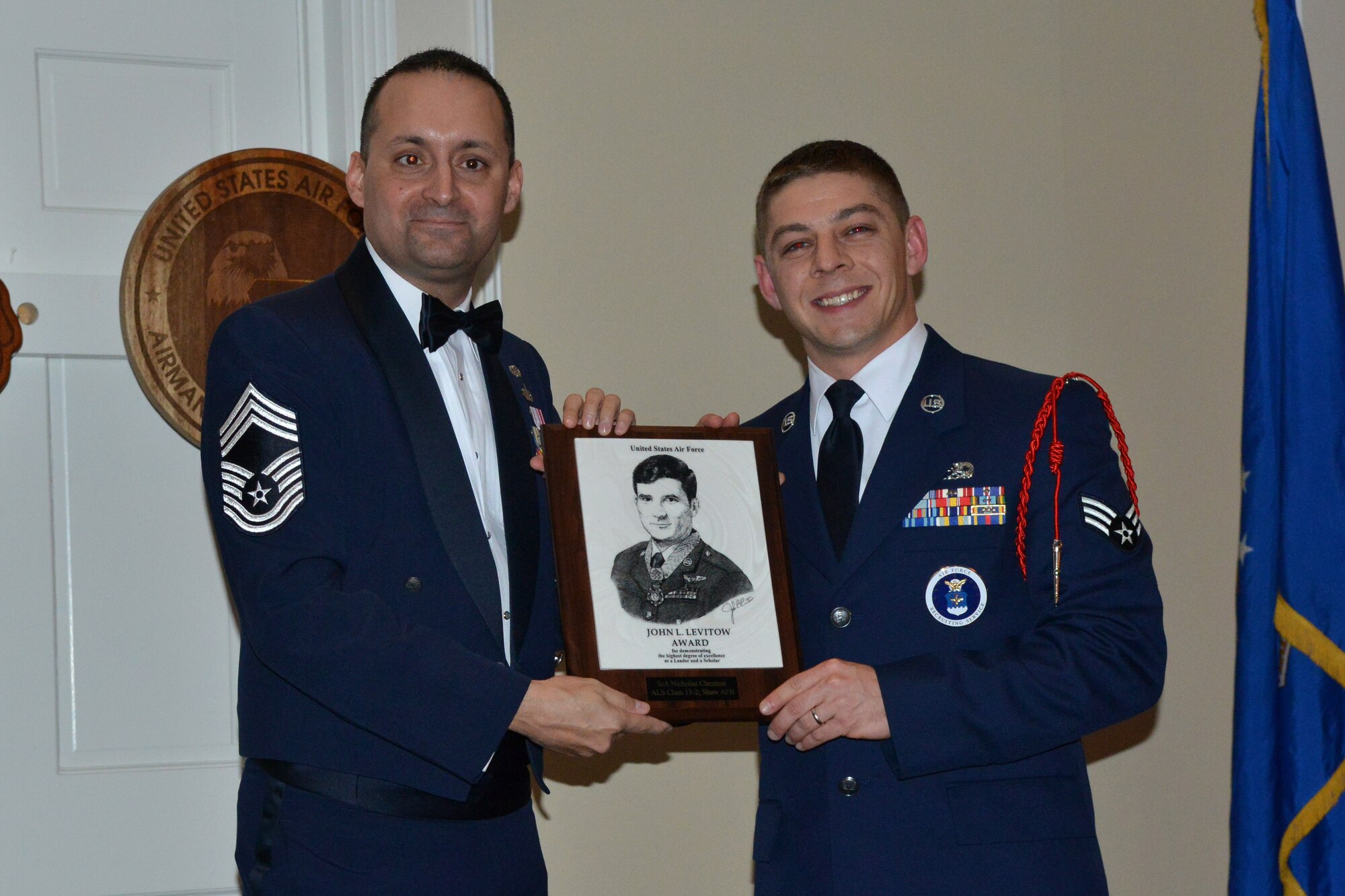 U.S. Air Force Chief Master Sgt. Michael Joseph, 20th Force Support Squadron superintendent, awards Senior Airman Nicholas Chestnut, 377th Recruiting Squadron enlisted accessions recruiter, his Airman Leadership School diploma, Shaw Air Force Base, S.C., Feb. 7, 2013. Chestnut was also awarded the John Levitow Award, which is earned by the person with the highest average of instructor and student points. It is the highest award in enlisted Professional Military Education. (U.S. Air Force photo/Airman 1st Class Ashley L. Gardner/Released)
