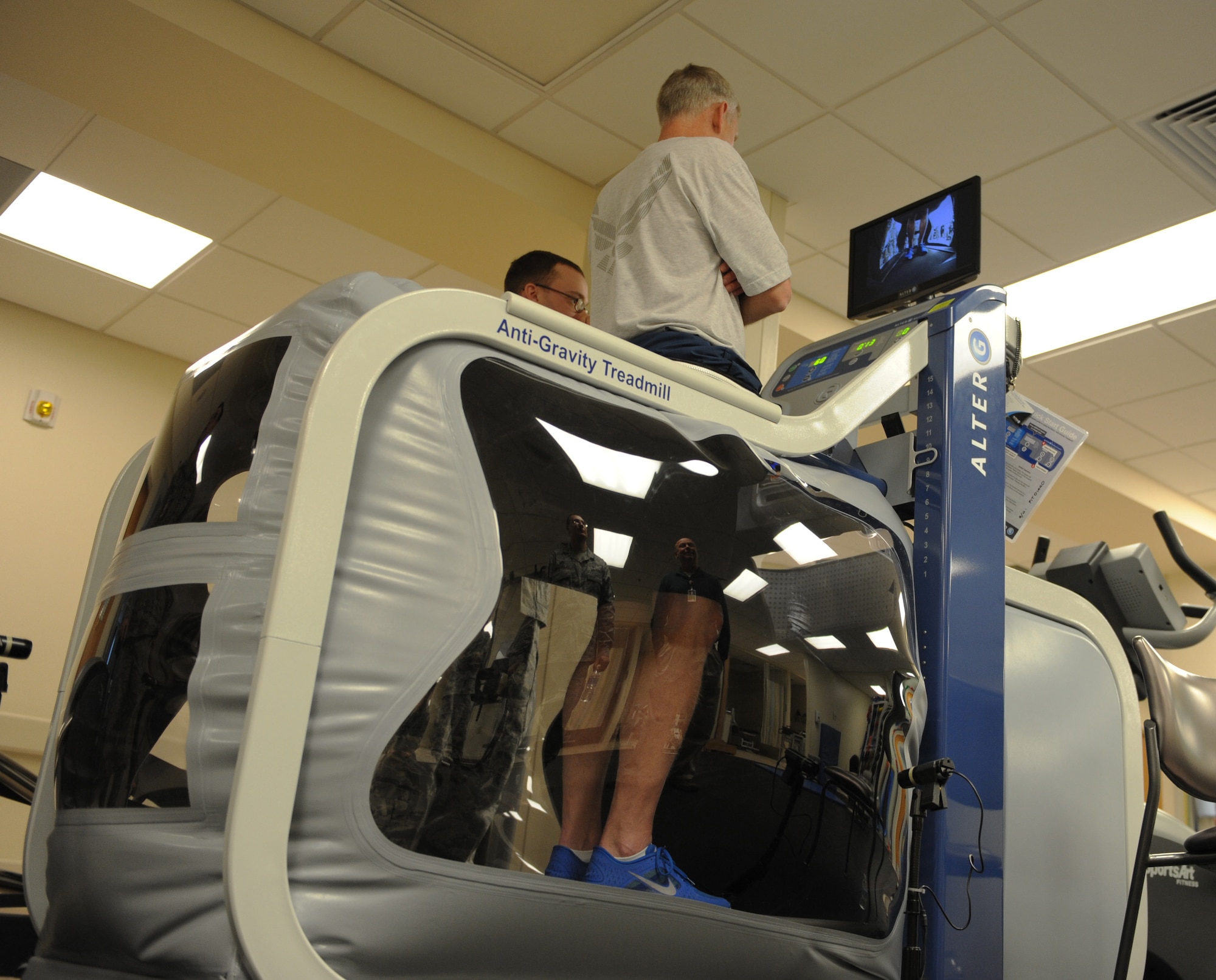 Col. David Almand, 375 Air Mobility Wing commander, goes runs on a anti-gravity treadmill called the Alter G in the Physical Therapy Clinic of the 375th Medical Group Jan. 4.  The Alter G can take up to 80% off a person's body weight using air pressure and allows a patient to run up to 12 mph.  The treadmill is useful for patients with ankle, knee and hip injuries, as well as post-operative patients and recent amputees who are getting used to their prosthetic limb(s).
