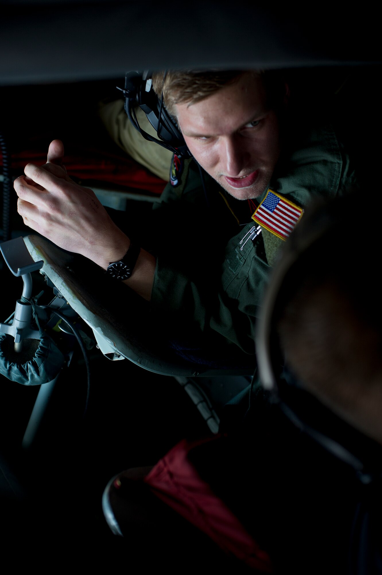 Senior Airman Travis Moore, 350th Air Refueling Squadron boom operator, explains how he performs in-flight refueling to a member of the Kansas Agriculture and Rural Leadership program Feb. 2, 2013. The flight was one part of a tour that showcased McConnell’s mission and heritage. (U.S. Air Force photo/Senior Airman Armando A. Schwier-Morales)  