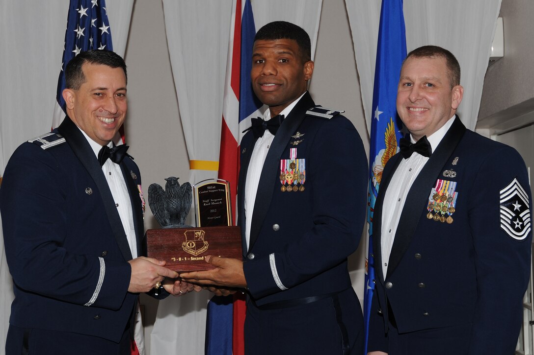 RAF CROUGHTON, United Kingdom – Lt. Col. Adisa Hinton, 422nd Communications Squadron commander, accepts the 501st Combat Support Wing’s Honor Guard of the Year on behalf of Staff Sgt. Karl Musick, 422nd CS, during the 501st CSW Annual Awards at RAF Croughton Feb. 8. Musick led the RAF Welford/Bicester Remembrance Day Parade where he honored World War I and World War II veterans. Throughout the year, he led 17 Airmen through 750 hours of ceremonies and events around RAF Croughton. (U.S. Air Force photo by Tech. Sgt. Chrissy Best)