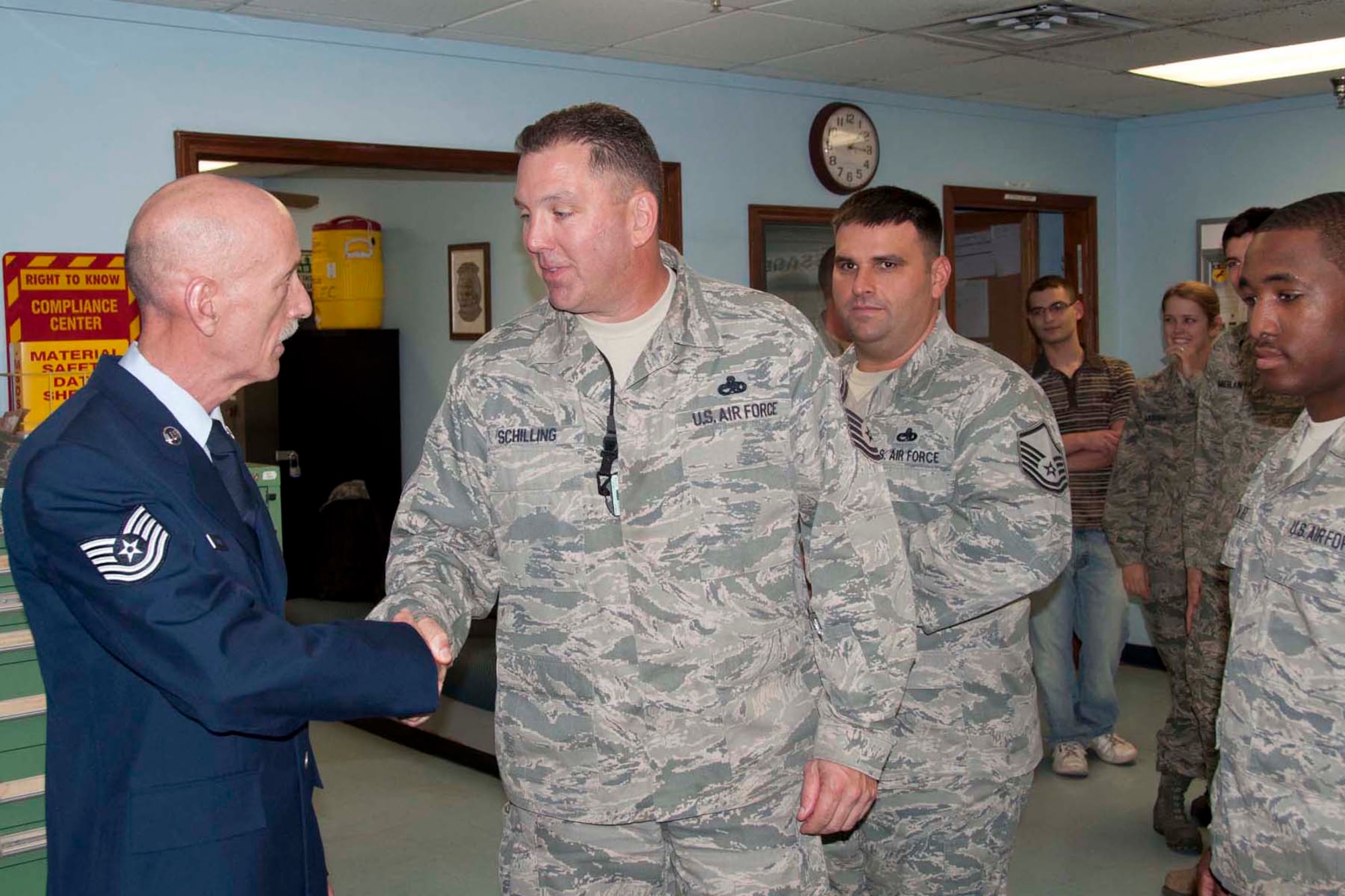 Senior Master Sgt. Kenneth Atchinson, who is the 307th Maintenance Squadron accessory flight chief, presents a plaque of appreciation to Tech. Sgt. John Harris, electrical and environmental systems mechanic, 307 MXS, at BarksdTech. Sgt. John Harris, who is a 307th Maintenance Squadron electrical and environmental systems mechanic, shakes hands for the last time with some members of the 307th MXS after his retirement ceremony at Barksdale Air Force Base, La., Feb. 9, 2013. A large crowd of well-wishers gathered at the ceremony to see Harris off.  He is retiring after more than 20 years of service to the Air Force Reserve. (U.S. Air Force by Tech. Sgt. Ted Daigle)ale Air Force Base, La., Feb. 9, 2013.  Harris accepted the gift during his retirement ceremony where he thanked members of the 307 MXS for the opportunity to serve with them.  He encouraged them to continue to display the professionalism they showed during his time in the unit. (U.S. Air Force by Tech. Sgt. Ted Daigle)