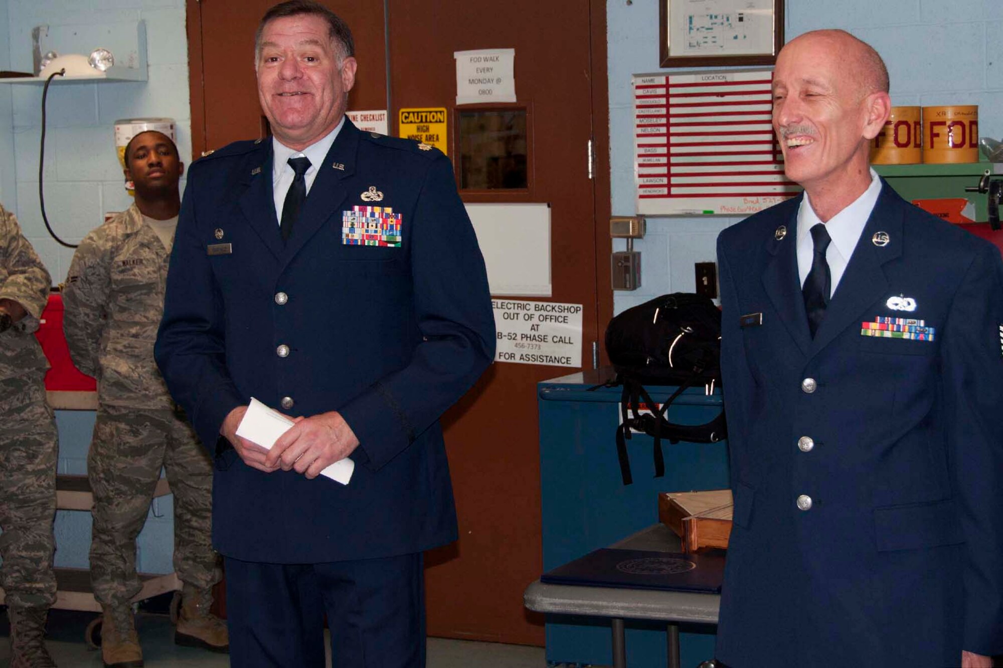 Maj. Leo Kamphaus, who is the 307th Maintenance Squadron commander, and Tech. Sgt. John Harris, a 307 MXS electrical and environmental systems mechanic, share a light moment during Harris’ retirement ceremony at Barksdale Air Force Base, La., Feb. 9, 2013. Kamphaus drew chuckles from the crowd while reflecting on the fact that Harris became a certified pilot at age 15, before he was even old enough to get a driver’s license.  Harris retired after more than 20 years of service in the Air Force Reserve.  (U.S. Air Force by Tech. Sgt. Ted Daigle)
