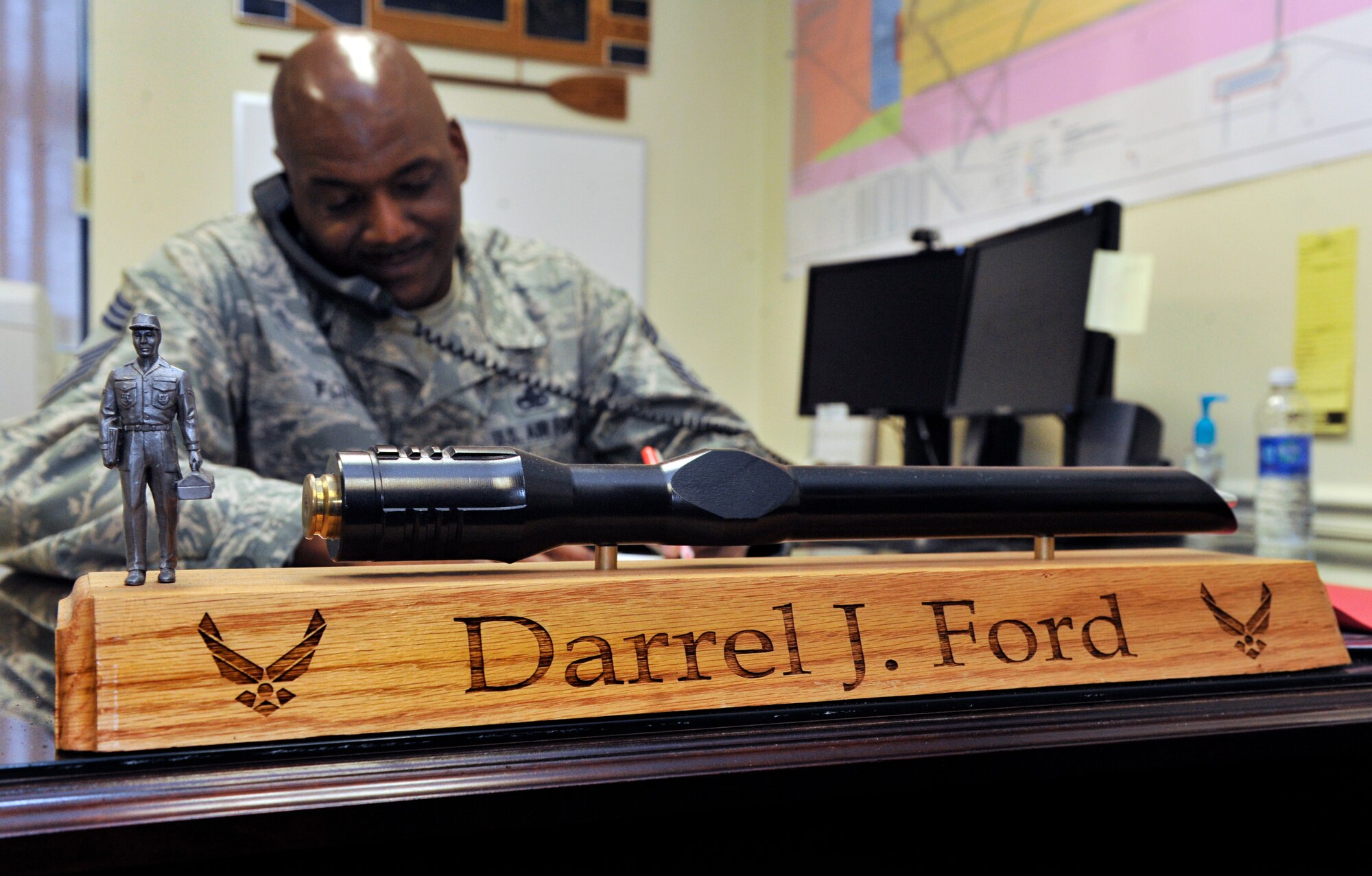 U.S. Air Force Chief Master Sgt. Darrel Ford, 20th Operations Group superintendent, takes a phone call during the course of a busy day, Shaw Air Force Base, S.C., Feb. 8, 2013. Ford has served in the Air Force for more than 27 years, and has had a long and successful career in maintenance and now operations. Ford aims to inspire others to lead and seek mentorship, he said. (U.S. Air Force photo by Senior Airman Amber E. N. Jacobs/Released)



