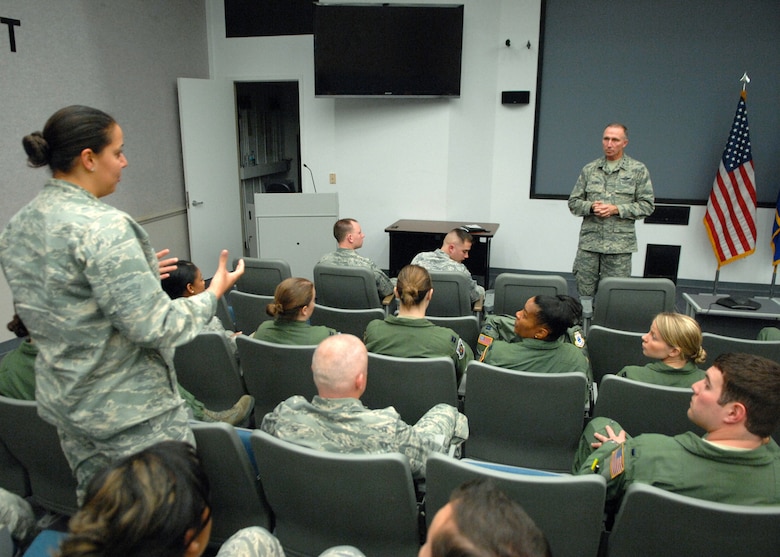 Capt. Jane Elzeftawy, left, a lawyer assigned to the 43rd Airlift Group, asks Maj. Gen. William Bender, U.S. Air Force Expeditionary Center commander, a question during a company grade officer "All Call" during the general’s visit to Pope Army Airfield, N.C., Feb. 8, 2103.  Maj. Gen. Bender along with his command chief, Chief Master Sgt. Jeffrey Cui, toured 43rd AG facilities, received mission briefings, conducted an "All Call" and served as the guest speaker for the group's annual awards banquet. 