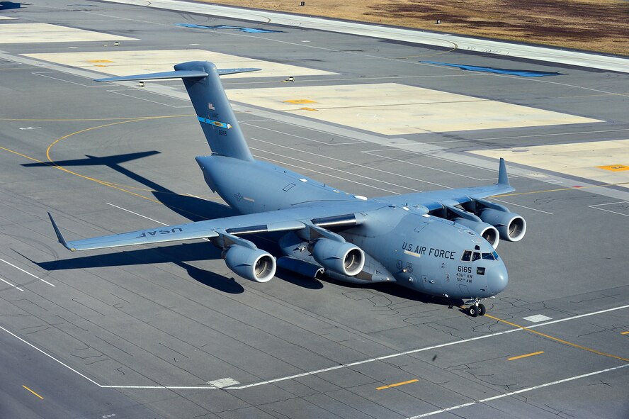 A  C-17 Globemaster lll aircraft taxis in front of the control tower on its way to the departure runway at Dover Air Force Base, Del., Jan 30, 2013. (U.S.Air Force photo/David S. Tucker)