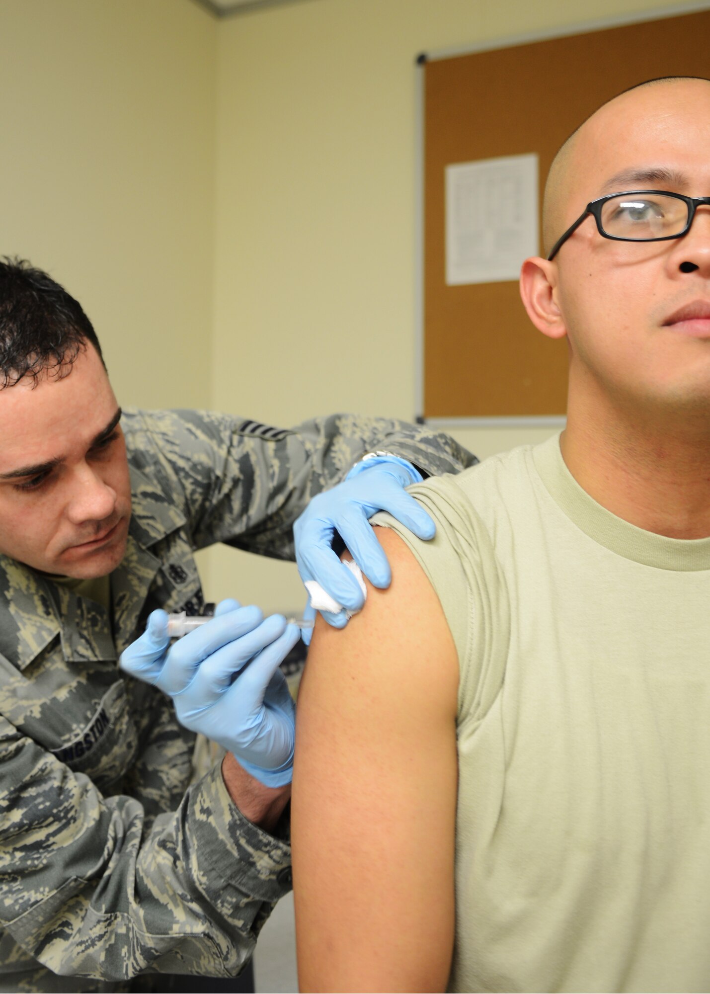 Tech. Sgt. Richard Sangston, 31st Medical Group allergy and immunizations technician, administers a vaccine to a patient Jan. 30 at Aviano Air Base, Italy. Last year, the immunizations clinic gave more than 16,000 vaccines to Team Aviano members. (U.S. Air Force photo/Airman 1st Class Briana Jones)