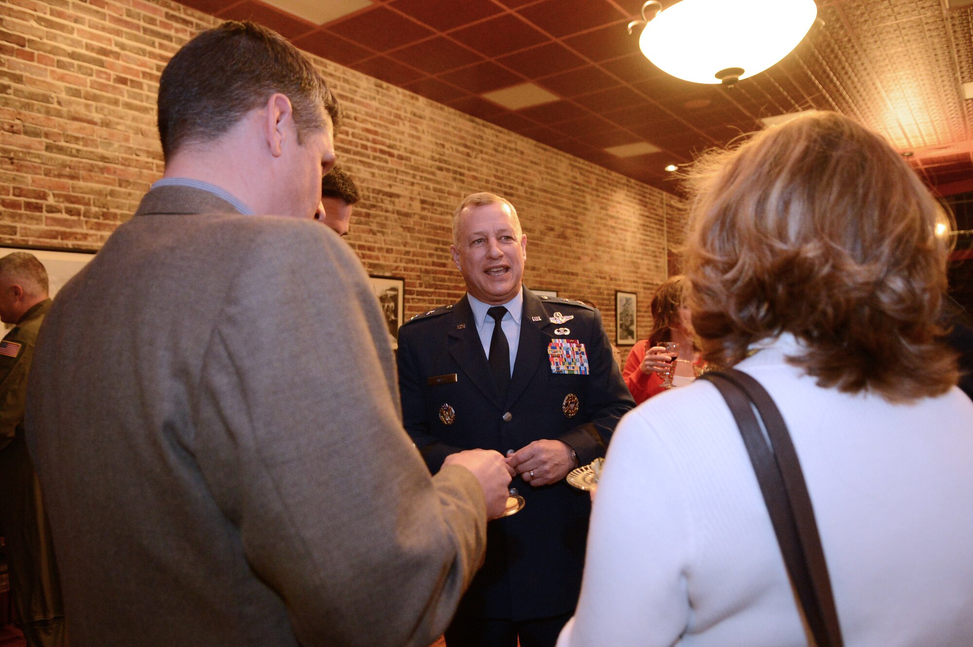 U.S. Air Force Maj. Gen. Lawrence Wells, 9th Air Force commander speaks with Col. Clay Hall, 20th Fighter Wing commander and his wife during the National Geographic premiere of Inside combat rescue at Sumter Opera House, Sumter, S.C., Feb. 9, 2013.  Airmen from Shaw and locals from the community gathered for a sneak peak at the documentary which will be released Feb. 18.  For the first time, cameras from National Geographic were allowed to follow t pararescue Airmen downrange and capture the experiences on the job that they face on a deployment. (U.S. Air Force photo by Airman 1st Class Nicole Sikorski/Released)
