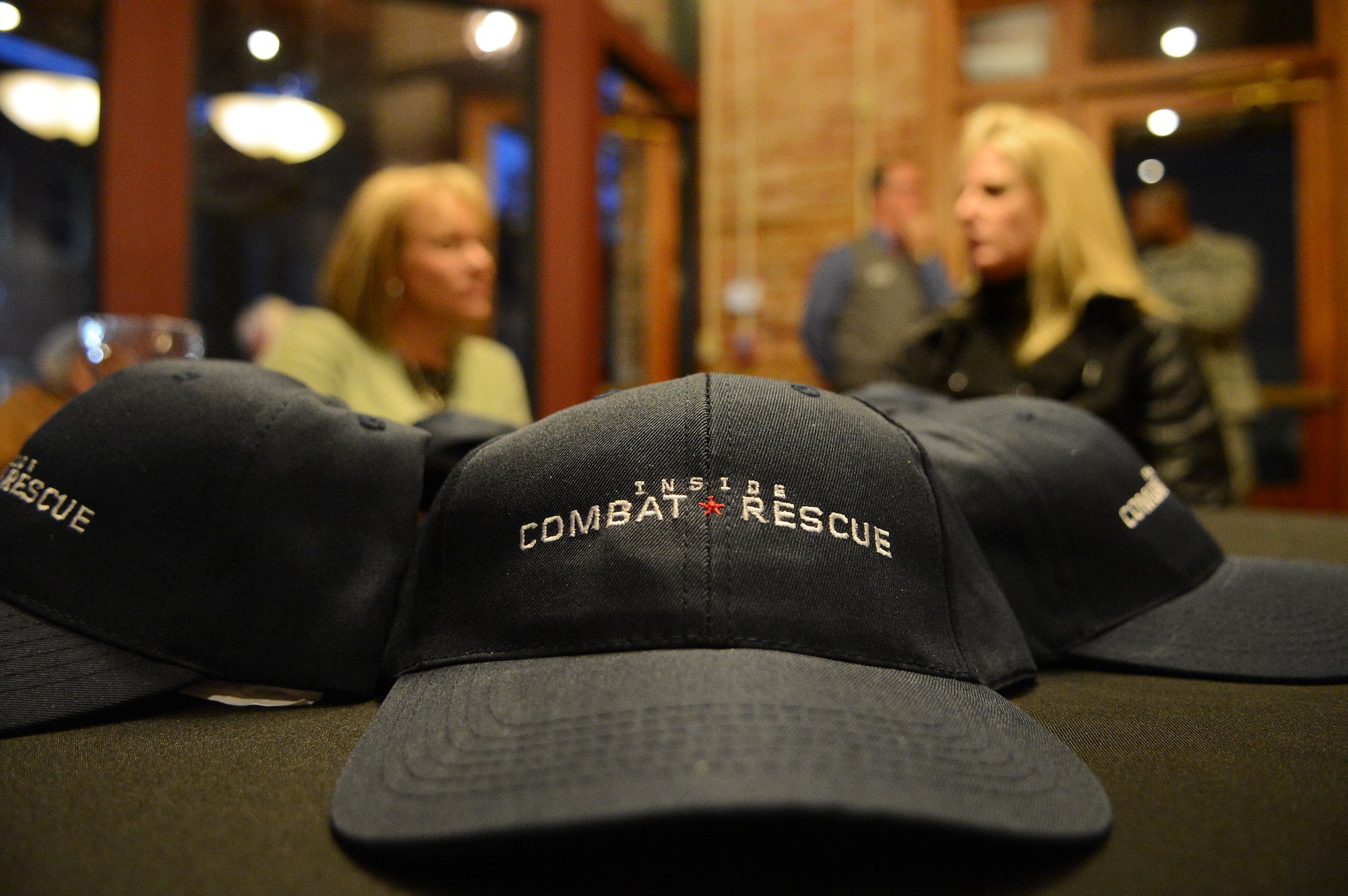 A hat advertising the new National Geographic documentary, Inside Combat Rescue, lies on a table at Sumter Opera House, Sumter, S.C., Feb. 9, 2013.  Airmen from Shaw and locals from the community gathered for a sneak peak at the documentary which will be released Feb. 18.  For the first time, cameras from National Geographic were allowed to follow pararescue Airmen downrange and capture the experiences that they face on a deployment. (U.S. Air Force photo by Airman 1st Class Nicole Sikorski/Released)