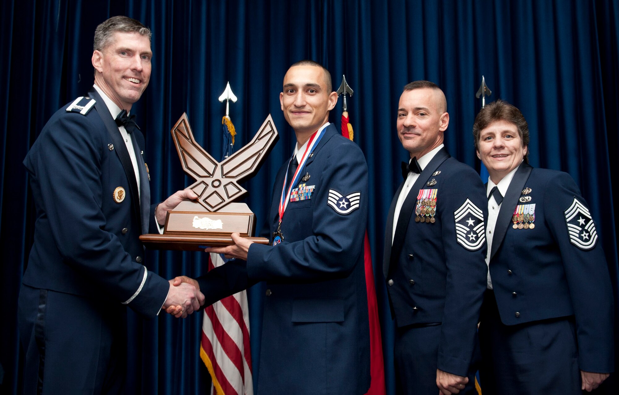 Staff Sgt. Robert Hernandez, 39th Communications Squadron, receives the 39th Air Base Wing Noncommissioned Officer of the Year award from Col. Chris Craige, 39th Air Base Wing commander, during the 2012 Annual Awards Banquet Feb. 8, 2013, at Incirlik Air Base, Turkey. (U.S. Air Force photo by Senior Airman Daniel Phelps/Released)