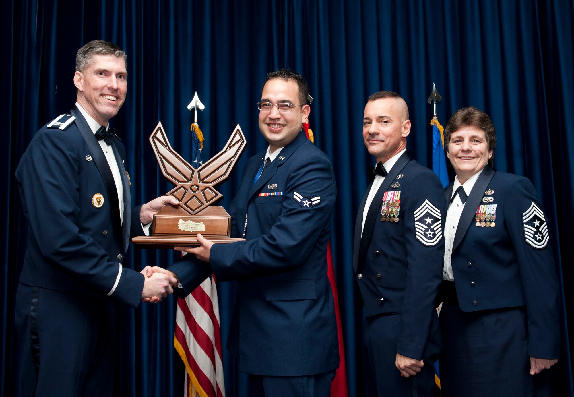 Airman 1st Class Eugenio Vives-Alvarez, 39th Communications Squadron, receives the 39th Air Base Wing Airman of the Year award from Col. Chris Craige, 39th Air Base Wing commander, during the 2012 Annual Awards Banquet Feb. 8, 2013, at Incirlik Air Base, Turkey. (U.S. Air Force photo by Senior Airman Daniel Phelps/Released)