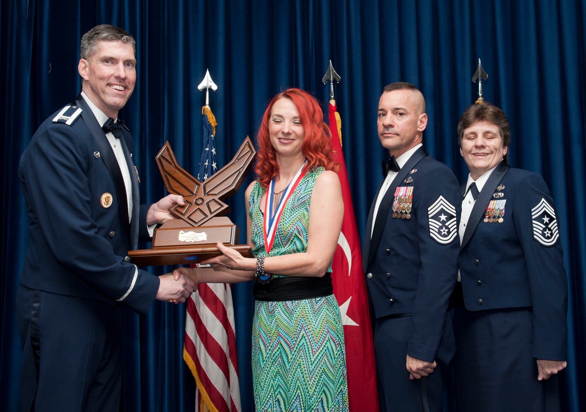 Lois Ritter, 39th Contracting Squadron, receives the 39th Air Base Wing Civilian of the Year Category II award from Col. Chris Craige, 39th Air Base Wing commander, during the 2012 Annual Awards Banquet Feb. 8, 2013, at Incirlik Air Base, Turkey. (U.S. Air Force photo by Senior Airman Daniel Phelps/Released)