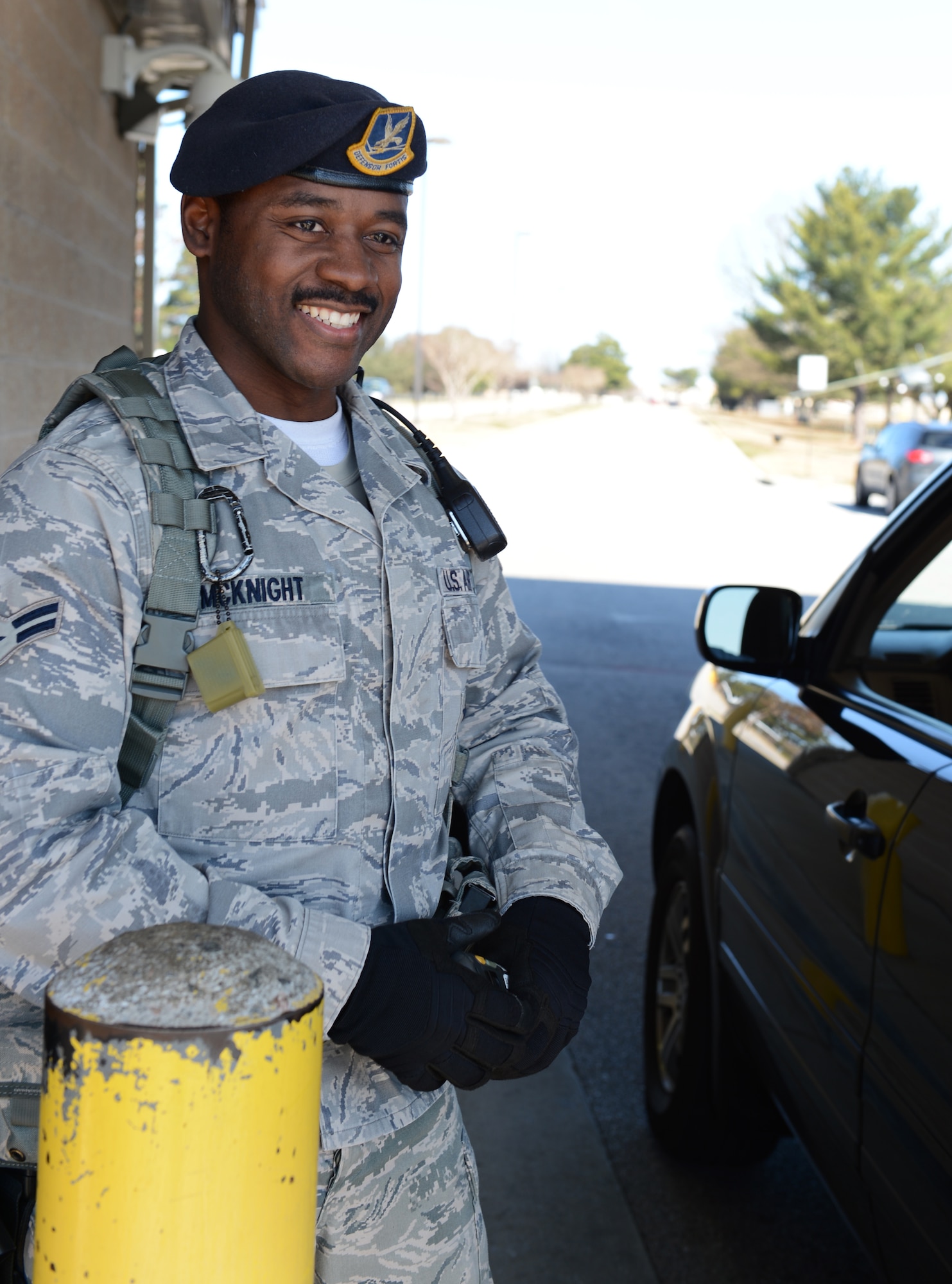 U.S. Air Force Airman 1st Class Kina McKnight, 20th Security Forces Squadron patrolman, smiles and wishes them a good day after checking identification of Shaw members, at Shaw Air Force Base, S.C., Feb.10, 2013. McKnight is the Shaw Spotlight for the week of Feb. 11 to Feb. 15. (U.S. Air Force photo by Senior Airman Tabatha Zarrella/Released)