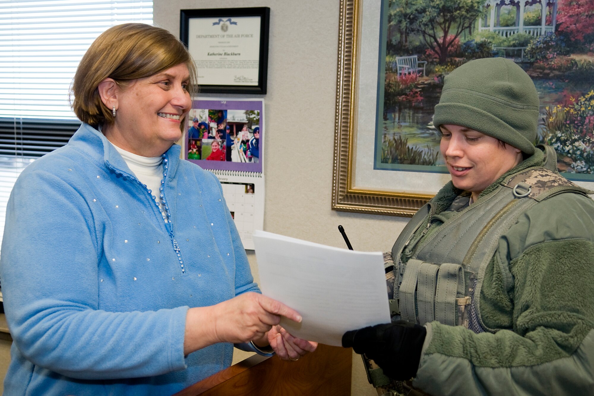 GRISSOM AIR RESERVE BASE, Ind. -- Katherine Blackburn, 434th Security Forces Squadron security assistant, works with Staff Sgt. Michelle Curtiss, 434th SFS security response team member, at the Grissom Visitors Center Feb. 1. Blackburn, a 33-year civil servant, was recently recognized by the Air Force Reserve Command with an Outstanding Security Forces Flight Level Civilian award. (U.S. Air Force photo/Tech. Sgt. Mark R. W. Orders-Woempner)
