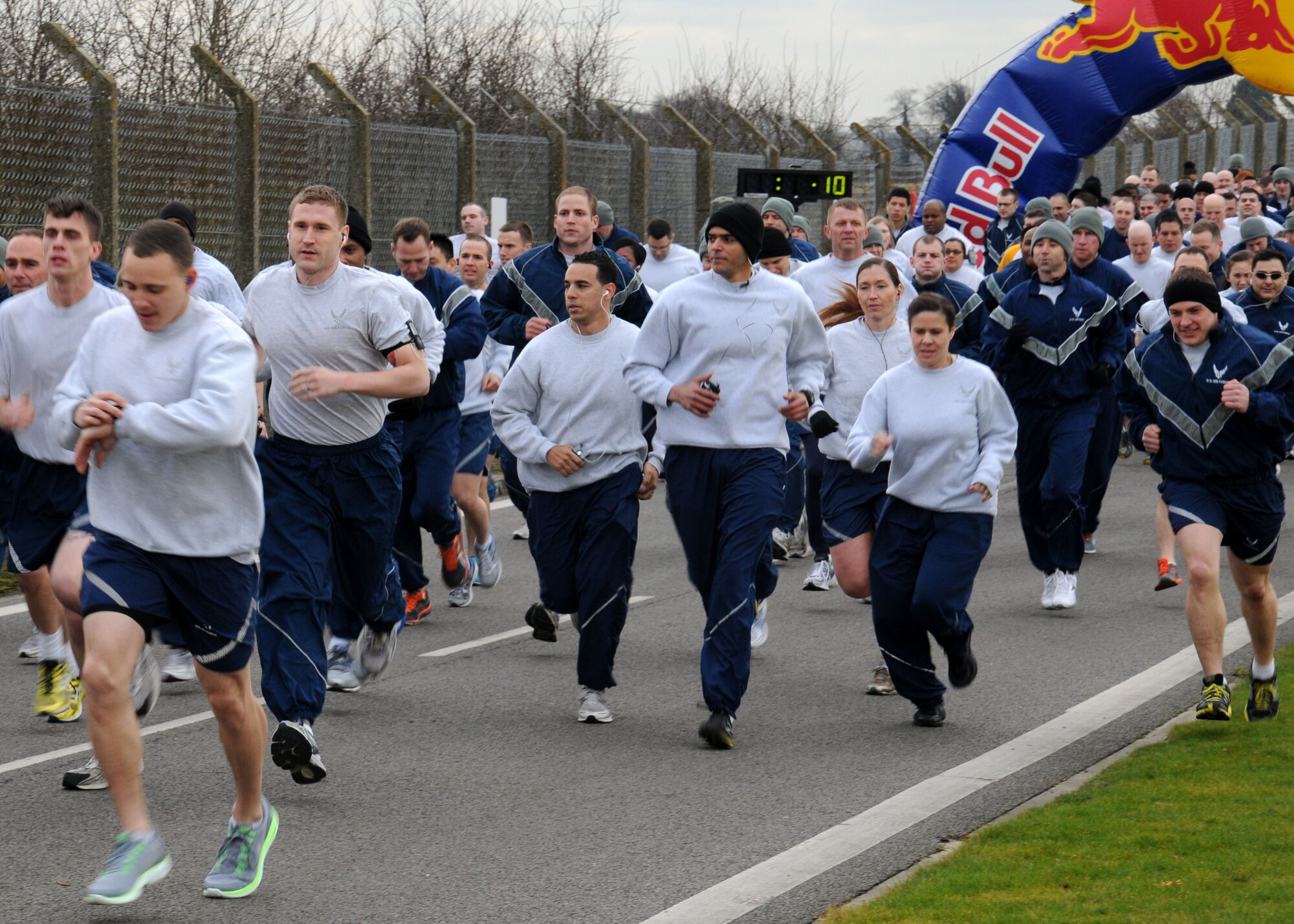 Team Mildenhall members take part in the monthly wing run Feb. 8, 2013, on Perimeter Road near the Hardstand Fitness Center on RAF Mildenhall, England. The run takes place on the first Friday of every month and is mandatory for all 100th Air Refueling Wing military personnel but tenant units and base ID card holders 13-years and older are welcome to attend. (U.S. Air Force photo by Gina Randall/Released)