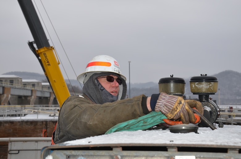 Joseph Gurin, operations, uses a clevis to connect equipment to a crane during dewatering construction at Lock and Dam 6, near Trempeauleau, Wis., Jan. 16.