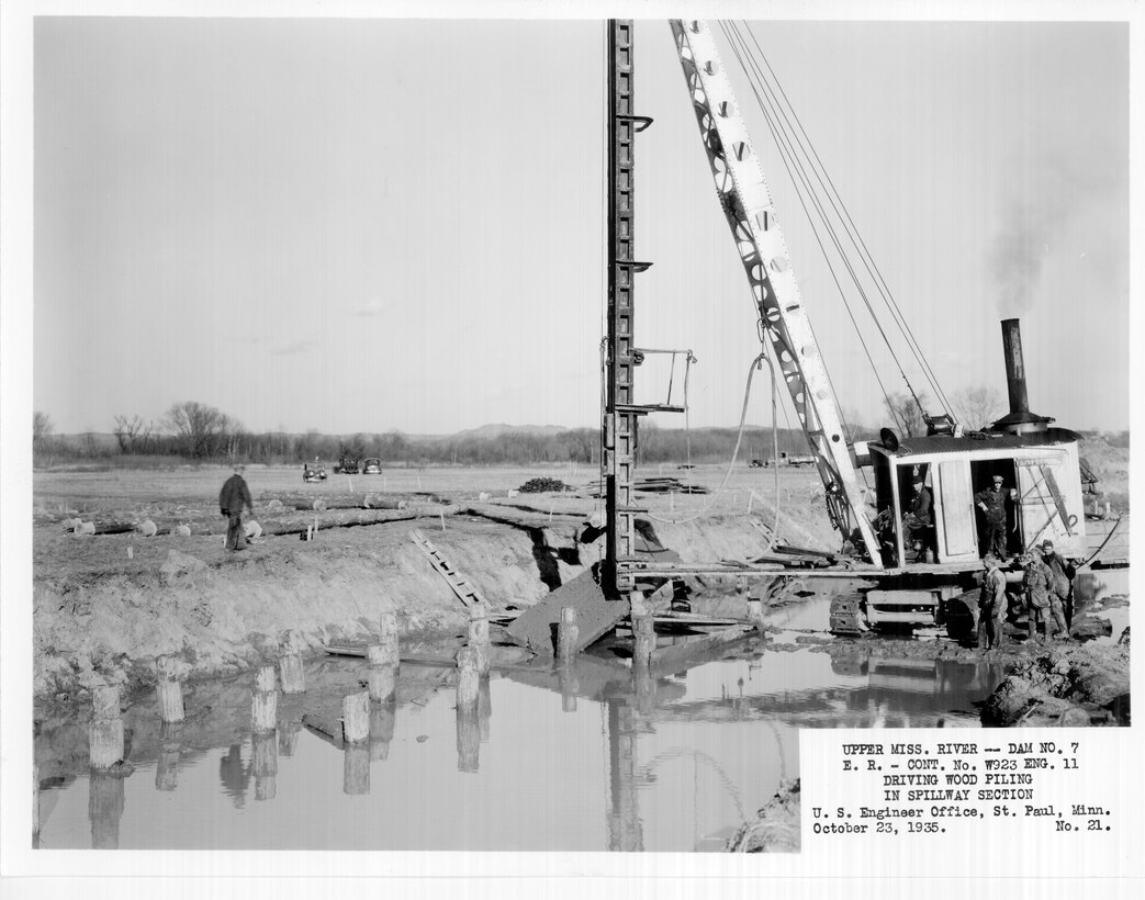 Construction of Lock and Dam 7 on the Upper Mississippi River in La Crescent, Minn., Oct. 23, 1935. Driving wood piling in spillway section.