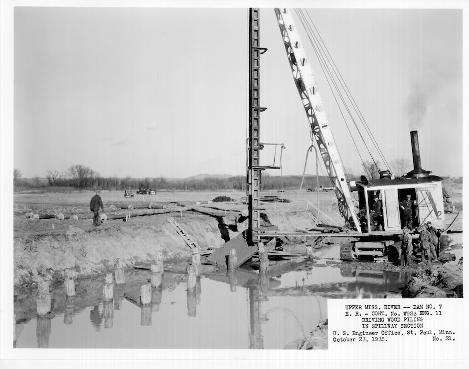 Construction of Lock and Dam 7 on the Upper Mississippi River in La Crescent, Minn., Oct. 23, 1935. Driving wood piling in spillway section.