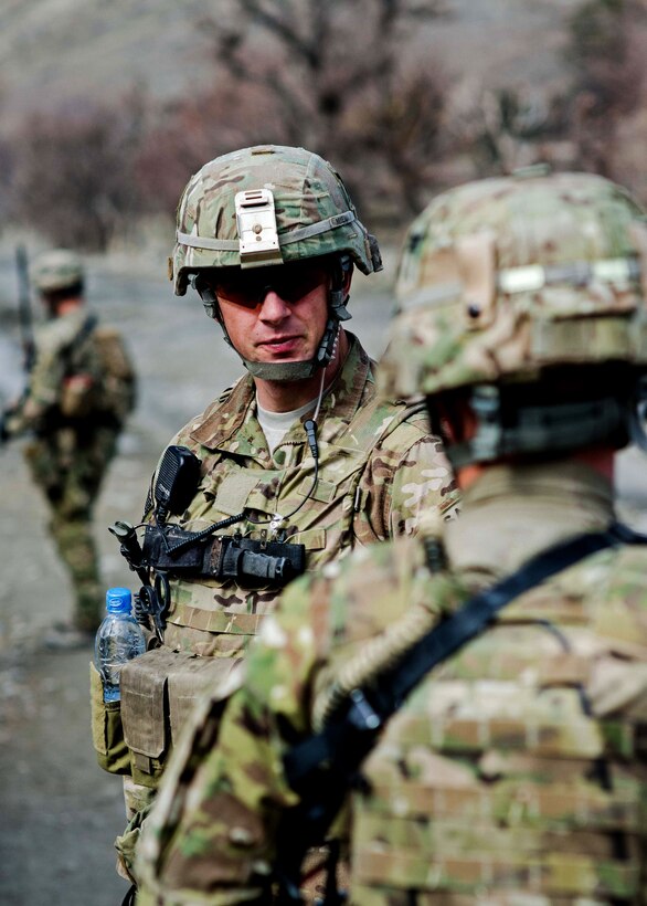 U.S. Army Sgt. Isaiah Myers, center, talks with his team as they pull security on a road near a remote village of Khowst province, Afghanistan, Jan. 31, 2013. Myers, a team lead, is assigned to the 101st Airborne Division’s Troop B, 1st Squadron, 33rd Cavalry Regiment, 3rd Brigade Combat Team.