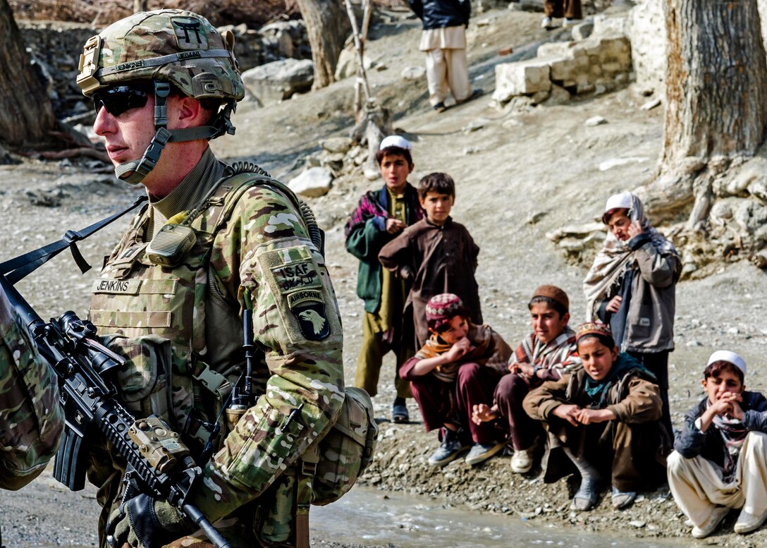 U.S. Army Capt. Andrew Jenkins is watched by Afghan children as he prepares to meet his counterparts from the Afghan army and Afghan police in a remote village of Khowst province, Afghanistan, Jan. 31. 2013. Jenkins is commander of the 101st Airborne Division’s Troop B, 1st Squadron, 33rd Cavalry Regiment, 3rd Brigade Combat Team.