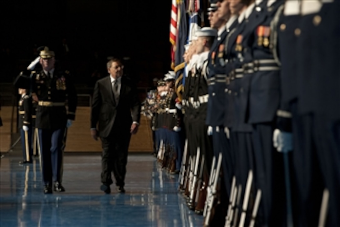 Regimental Commander Col. James Markert, left, escorts Secretary of Defense Leon E. Panetta as he performs a front line inspection of the troops during an armed forces farewell tribute in his honor at Joint Base Meyer-Henderson Hall, Va., on Feb. 8, 2013.  Panetta is stepping down as the 23rd secretary of defense.  