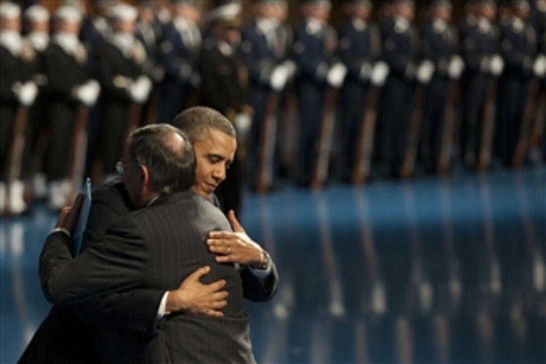 President Barack Obama hugs Secretary of Defense Leon E. Panetta during an armed forces farewell tribute in honor of Panetta at Joint Base Meyer-Henderson Hall, Va., on Feb. 8, 2013.  Panetta is stepping down as the 23rd secretary of defense.  