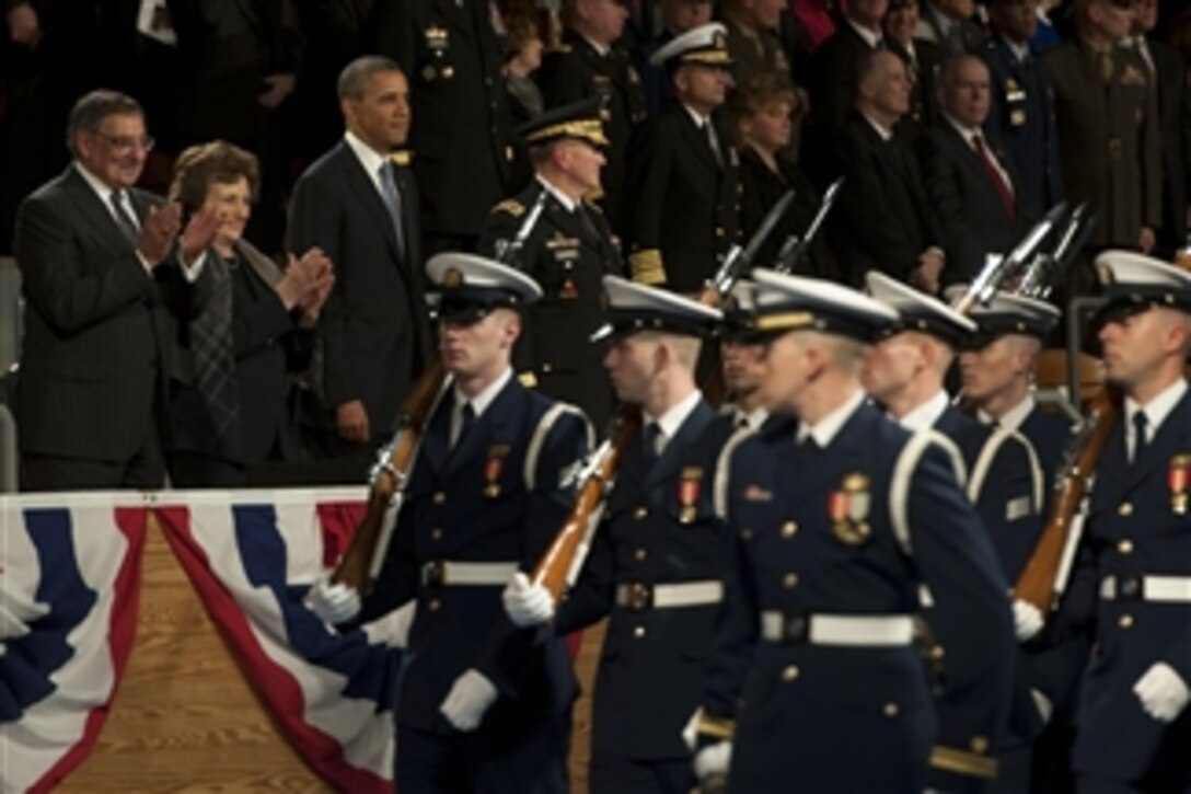 Secretary of Defense Leon E. Panetta, left, Sylvia Panetta, second from left, President Barack Obama, center, and Chairman of the Joint Chiefs of Staff Gen. Martin E. Dempsey, right, applaud and watch the pass in review during an armed forces farewell tribute in honor of Panetta at Joint Base Meyer-Henderson Hall, Va., on Feb. 8, 2013.  Panetta is stepping down as the 23rd secretary of defense.  