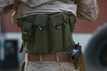 Staff Sgt. Samuel A. Beltram, an explosive ordnance disposal technician with 8th Engineer Support Battalion, 2nd Marine Logistics Group, reveals a simulated explosive vest hidden under his uniform during a training exercise aboard Camp Lejeune, N.C., Feb. 7, 2013. Beltram used the vest as a final test for students with Combat Logistics Battalion 22, 2nd MLG as they worked their way through an improvised explosive device training field.