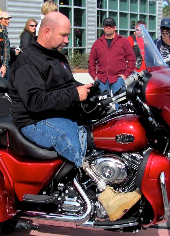 On the third anniversary of his survival, recently retired Sgt. Maj. Raymond H. Mackey, a double amputee with Wounded Warrior Battalion East, mounted his brand new Harley Davidson Tri-Glide for the first time on Dec. 23, 2012, in Jacksonville N.C. Mackey, who has ridden motorcycles for more than 35 years, lost his legs in an improvised explosive device accident while serving with 3rd Battalion 10th Marine Regiment, in Helmand province Afghanistan in 2009.