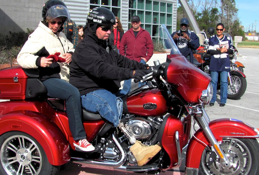 On the third anniversary of his survival, recently retired Sgt. Maj. Raymond H. Mackey, a double amputee with Wounded Warrior Battalion East, mounted his brand new Harley Davidson Tri-Glide for the first time with his wife on Dec. 23, 2012, in Jacksonville N.C. Mackey, who has ridden motorcycles for more than 35 years, lost his legs in an improvised explosive device accident while serving with 3rd Battalion 10th Marine Regiment, in Helmand province Afghanistan in 2009.