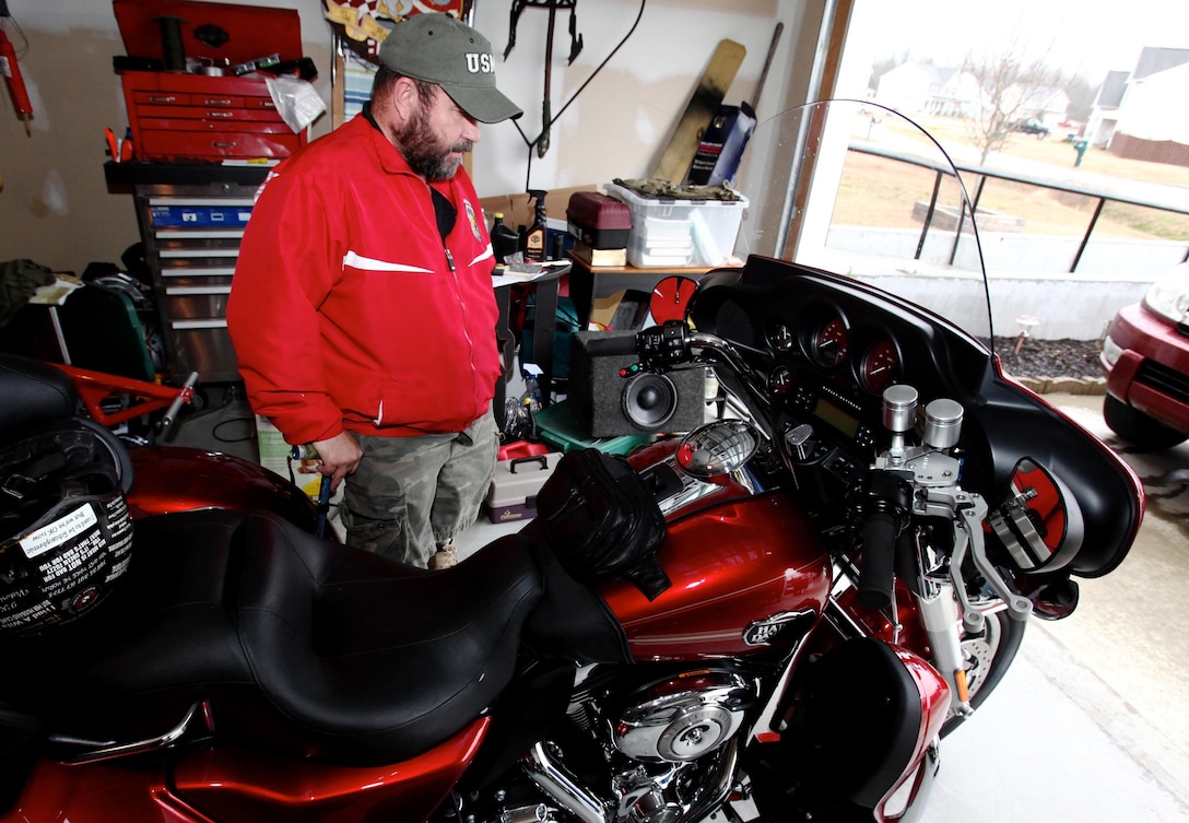 Recently retired Sgt. Maj. Raymond H. Mackey, a double amputee with Wounded Warrior Battalion East, explains the functions of his custom made Harley Davidson Tri-Glide and the specially installed hand controls on Feb. 7, 2013, at his home, in Beulaville, N.C. Mackey, who has ridden motorcycles for more than 35 years, lost his legs in an improvised explosive device accident while serving with 3rd Battalion 10th Marine Regiment, in Helmand province Afghanistan in 2009.