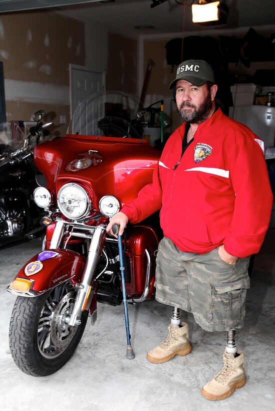 Recently retired Sgt. Maj. Raymond H. Mackey, a double amputee with Wounded Warrior Battalion East, stands next to his custom made Harley Davidson Tri-Glide on Feb. 7, 2013, at his home, in Beulaville, N.C. Mackey, who has ridden motorcycles for more than 35 years, lost his legs in an improvised explosive device accident while serving with 3rd Battalion 10th Marine Regiment, in Helmand province Afghanistan in 2009.