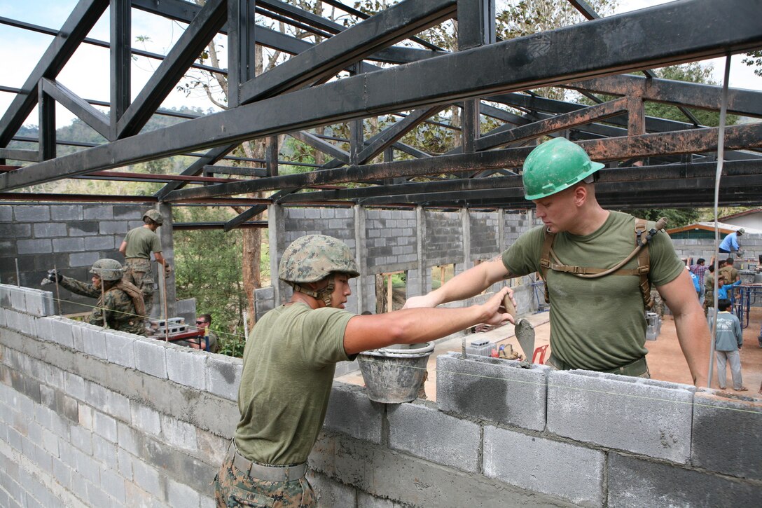 U.S. Marines stack cement blocks Feb. 1 during construction of a new building at Ban Kuad Nam Man School, Chat Trakarn District, Phitsanulok province, Kingdom of Thailand. Four similar structures are being built throughout the Kingdom of Thailand during ongoing engineering civic assistance projects part of Exercise Cobra Gold 2013. U.S. involvement in CG 13 demonstrates commitment to building military-to-military interoperability with participating nations and to supporting peace and stability throughout the region. U.S. Marines are with 9th Engineer Support Battalion, 3rd Marine Logistics Group, III Marine Expeditionary Force.