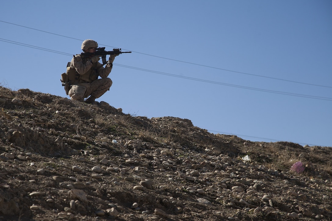 U.S. Marine Corps 1st Lt. William Kavanagh, company executive officer with Echo Company, 2nd Battalion, 7th Marines, Regimental Combat Team 7, observes distant objects with his rifle combat optic in Kajaki, Afghanistan, Feb. 8, 2013. The Marines of Echo Company are deployed to Afghanistan in support of Operation Enduring Freedom. (U.S. Marine Corps photo by Kowshon Ye/Released)