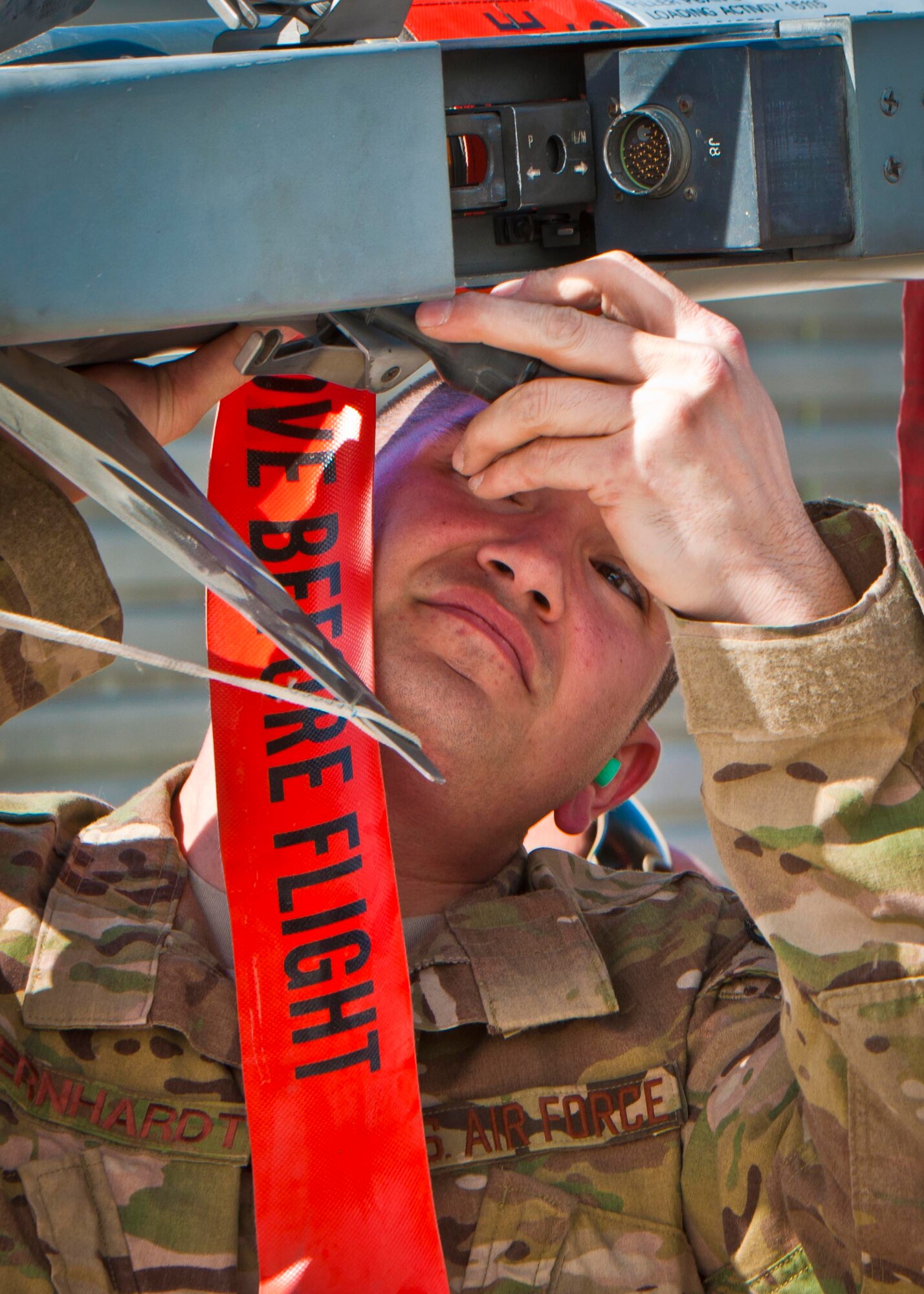 KANDAHAR AIRFIELD, Afghanistan -- Staff Sgt. William Bernhardt, 451st Expeditionary Aircraft Maintenance Squadron weapons load team chief, connects an AIM-9M missile to a missile launcher during a weapons load competition here Feb. 11. Bernhardt and two other Airmen made up a three-man weapons load crew and completed a four-phase evaluation. Their overall score will be put up against other scores of weapons loading crews from their home station, Shaw Air Force Base, S.C. (U.S. Air Force photo/Senior Airman Scott Saldukas)